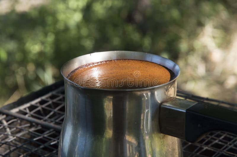 Closeup Turkish Coffee Pot on the Woodfired Grill Stock Photo