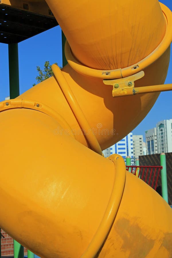 Close up of a twisted yellow tube slide