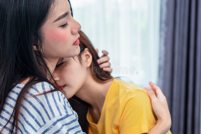 Close Up Of Two Asian Lesbian Women Looking Together In Bedroom Stock 