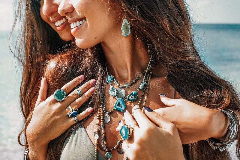 Close up of two cheerful stylish women twin sisters having fun outdoors