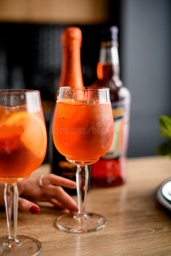 Close-up of two glasses of cold orange drink stand on the kitchen table. stock photo