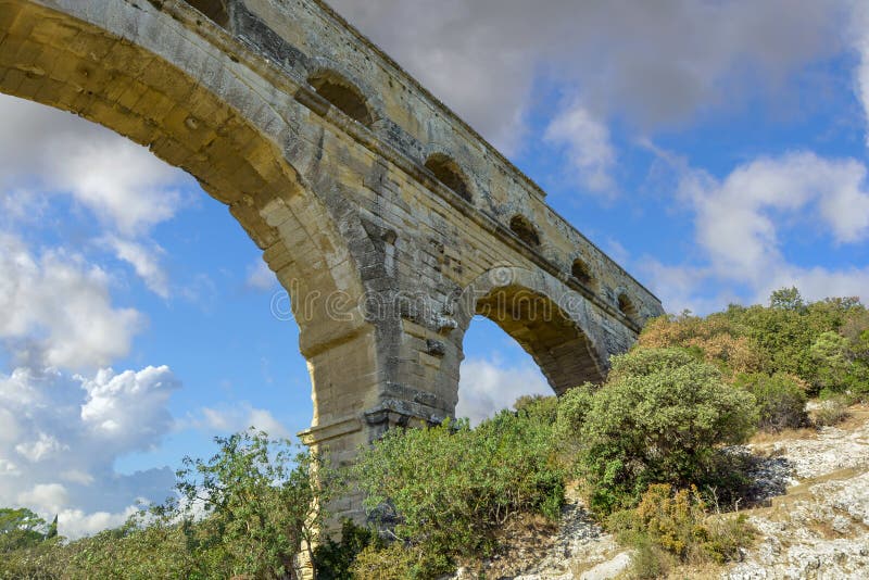 Close up from underneath the ancient Roman aqueduct Pont du Gard above the Gardon River in the Normandy region of France stock photos Close up from underneath the ancient Roman aqueduct Pont du Gard above the Gardon River in the Normandy region of France stock photos