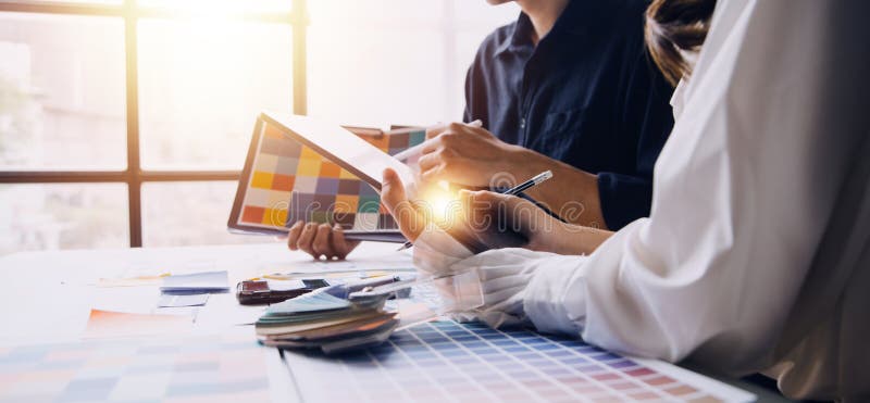 Close up ux developer and ui designer brainstorming about mobile app interface wireframe design on table with customer breif and royalty free stock photos