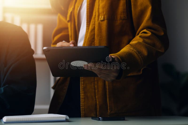 Close up ux developer and ui designer brainstorming about mobile app interface wireframe design on table with customer breif and royalty free stock image