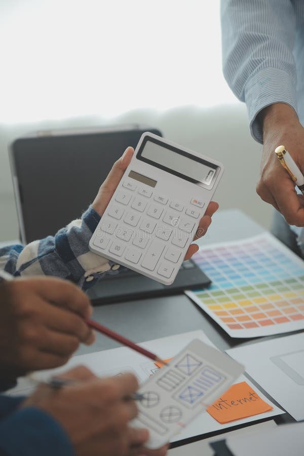 Close up ux developer and ui designer brainstorming about mobile app interface wireframe design on table with customer breif and royalty free stock images