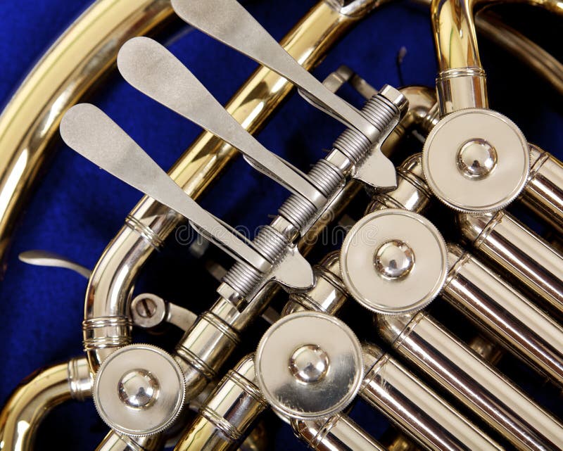 Close up of the valves and keys of a french horn stock photography Close up of the valves and keys of a french horn stock photography
