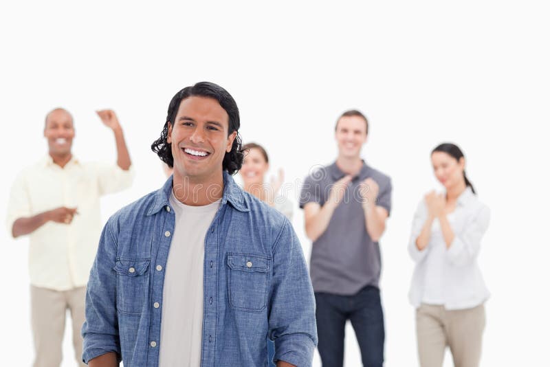 Close-up of a men laughing with people applauding in background. Close-up of a men laughing with people applauding in background