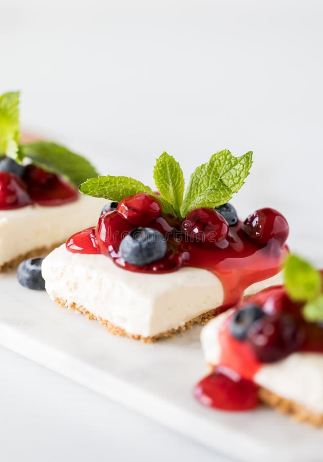 A Close Up Vertical View of a Row of Cherry Cheesecake Squares