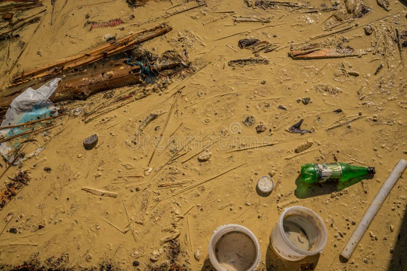 Close up view from above of polluted dirty muddy water with debris, garbage and plastic. royalty free stock photos Close up view from above of polluted dirty muddy water with debris, garbage and plastic. royalty free stock photos