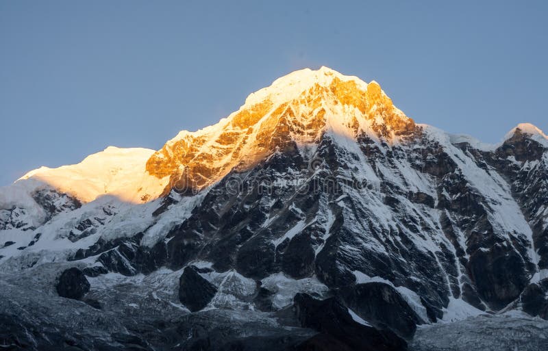 Close-up view of Annapurna South montain peak during sunrise golden hour against clear blue sky, Nepal royalty free stock images Close-up view of Annapurna South montain peak during sunrise golden hour against clear blue sky, Nepal royalty free stock images