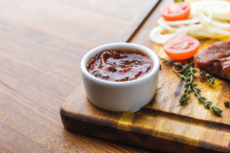Close-up view of bbq sauce and roasted meat with vegetables stock image Close-up view of bbq sauce and roasted meat with vegetables stock image