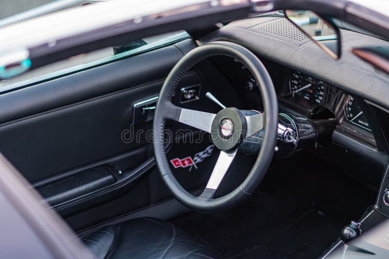 Close-up view of black and silver Corvette interior, emphasizing the high-end steering wheel with intricate design Soft lighting royalty free stock image