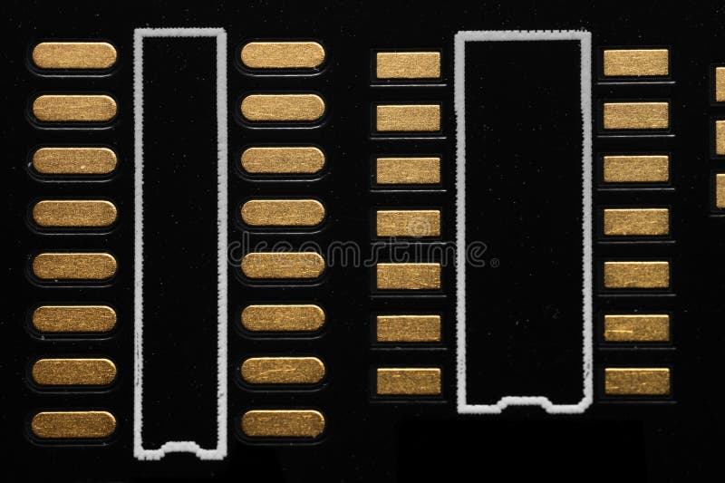 Close up view of blank electronic chip copper terminals on black PCB