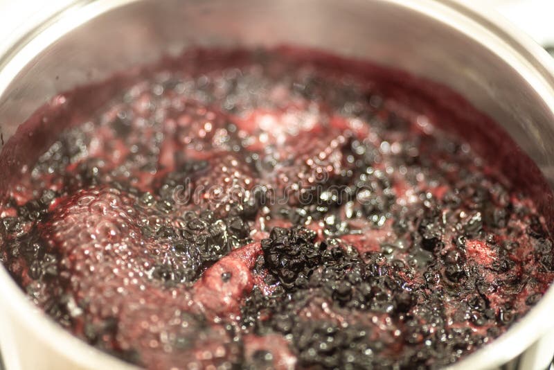 Close-up view of boiling blueberries. Cooking blueberry jam. stock photography Close-up view of boiling blueberries. Cooking blueberry jam. stock photography