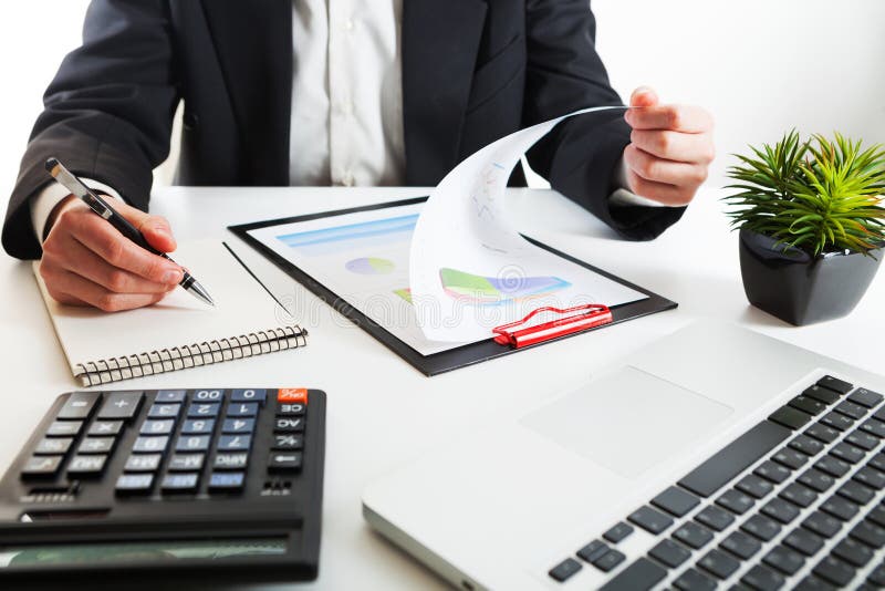 Close up view of bookkeeper or financial inspector hands making report, calculating or checking balance. Marketing strategy brainstorming. Paperwork and digital in office.