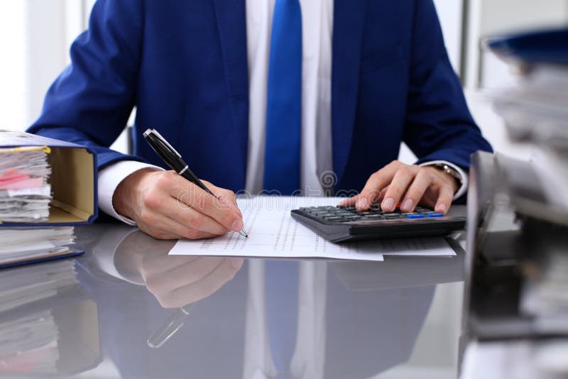 Close up view of bookkeeper or financial inspector hands making report, calculating or checking balance stock image Close up view of bookkeeper or financial inspector hands making report, calculating or checking balance stock image
