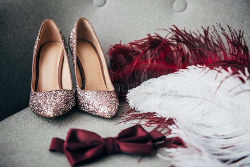 close up view of bridal shoes, grooms bow tie and feathers for rustic wedding stock images close up view of bridal shoes, grooms bow tie and feathers for rustic wedding stock images