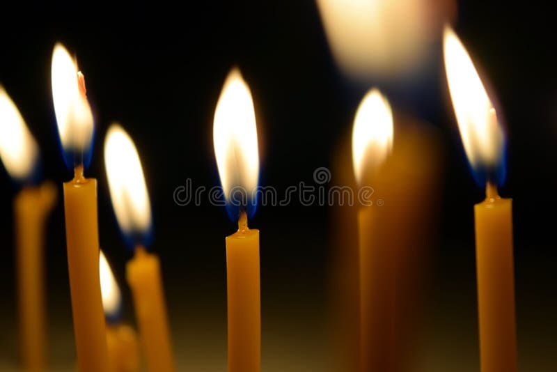 Close Up View of the Candles Burning Brightly in the Dark. Stock Photo