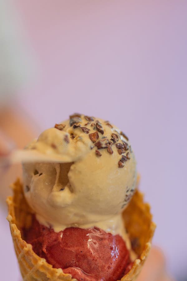 A Double Scoop Vanilla Ice Cream Cone on a Bright Pink Background Stock