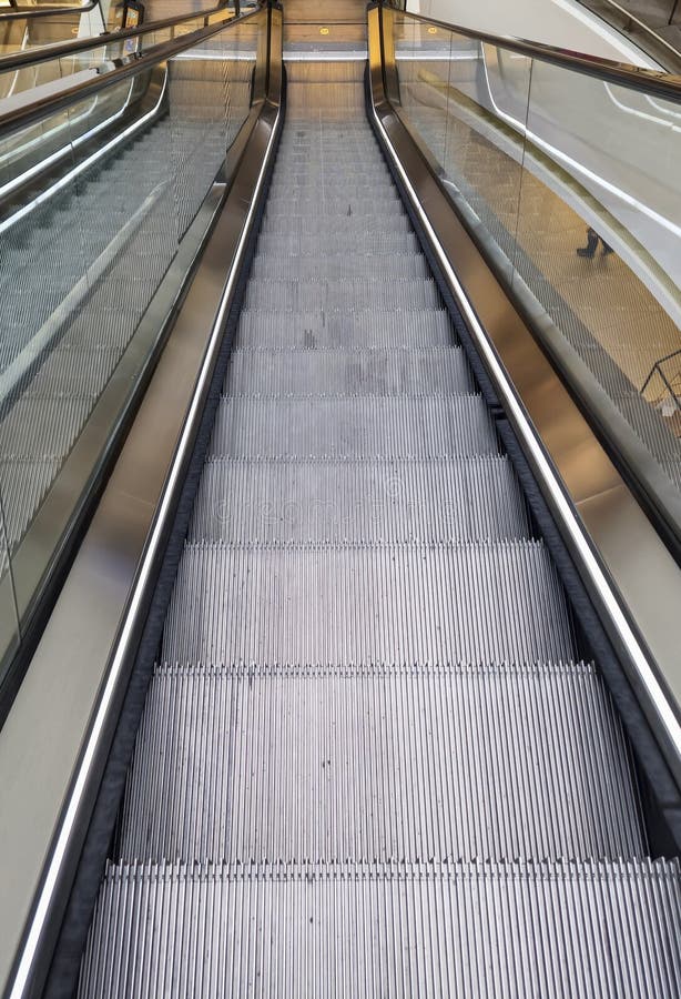 A close-up view of an escalator showcasing its metallic steps and modern design. Perfect for urban settings, architectur stock image