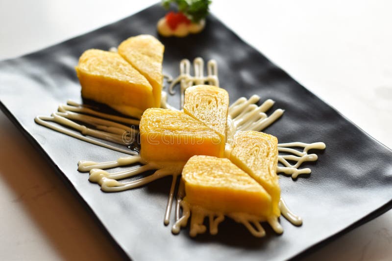 Close-up view, Japanese sweet eggs on black plate royalty free stock photos