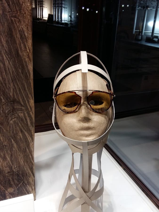 Close up view of mannequin with various fashionable sunglass in shop