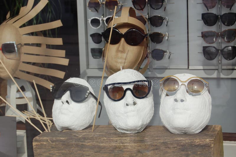 Close up view of mannequins with various fashionable sunglasses in shop