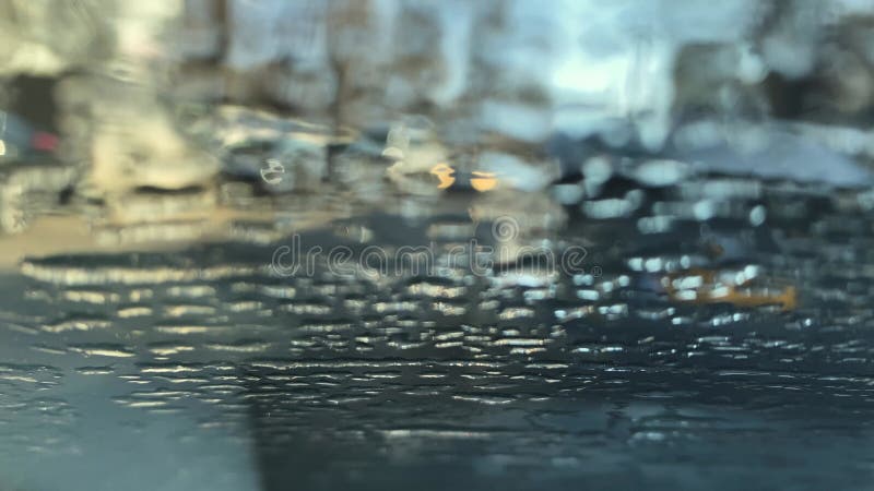 Close-up view of melting ice on the surface of car window
