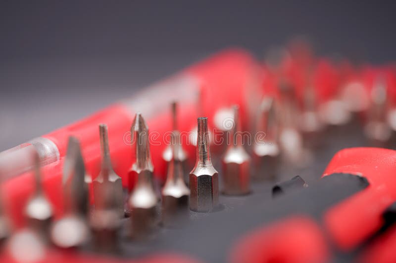 Close-up view of metal screwdriver bits arranged precisely in tool holder for easy access during repair work royalty free stock photo