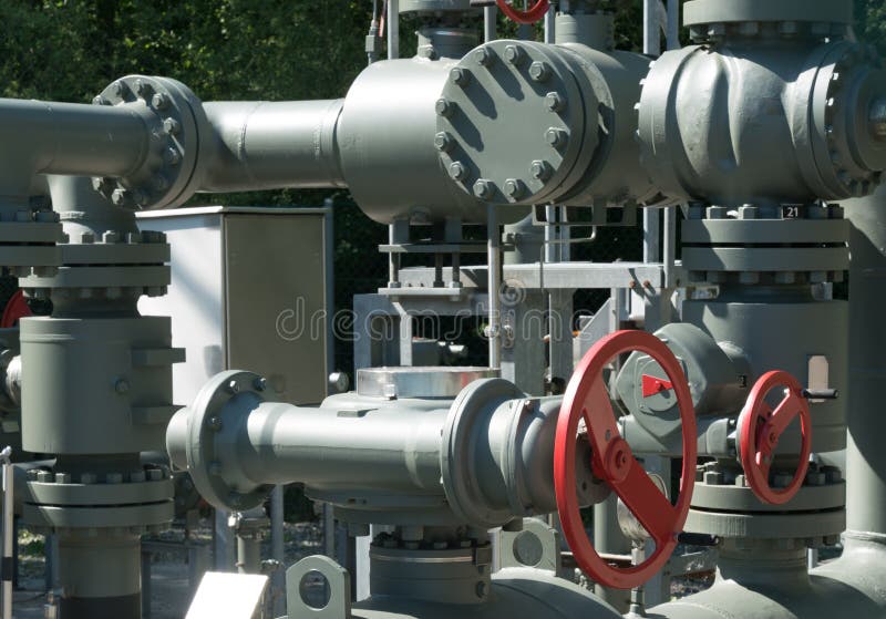 Intricate system of metal pipes and valves and wheels used to regulate water and sewage stock photo