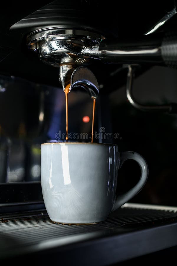 Espresso machine pouring coffee in cups Stock Photo by ©bogdan