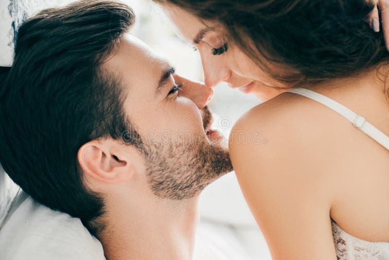 close-up view of seductive happy young couple able to kiss in foreplay stock photo close-up view of seductive happy young couple able to kiss in foreplay stock photo