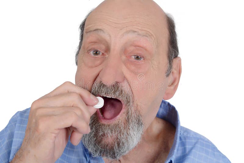 Close up view of senior man taking pill stock photography Close up view of senior man taking pill stock photography