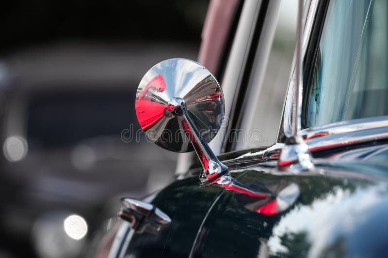 Close up view of shiny side view mirror on a classic car. Close up shot of shiny side view mirror on a classic car