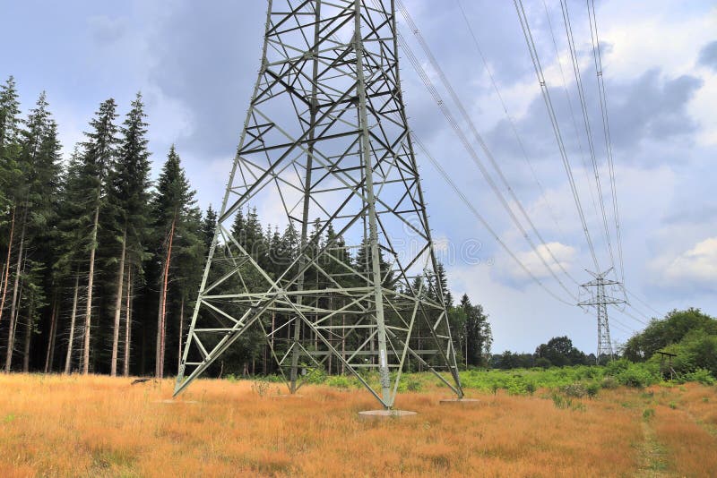 Close up view on a steel power pylon with high voltage power lines royalty free stock images