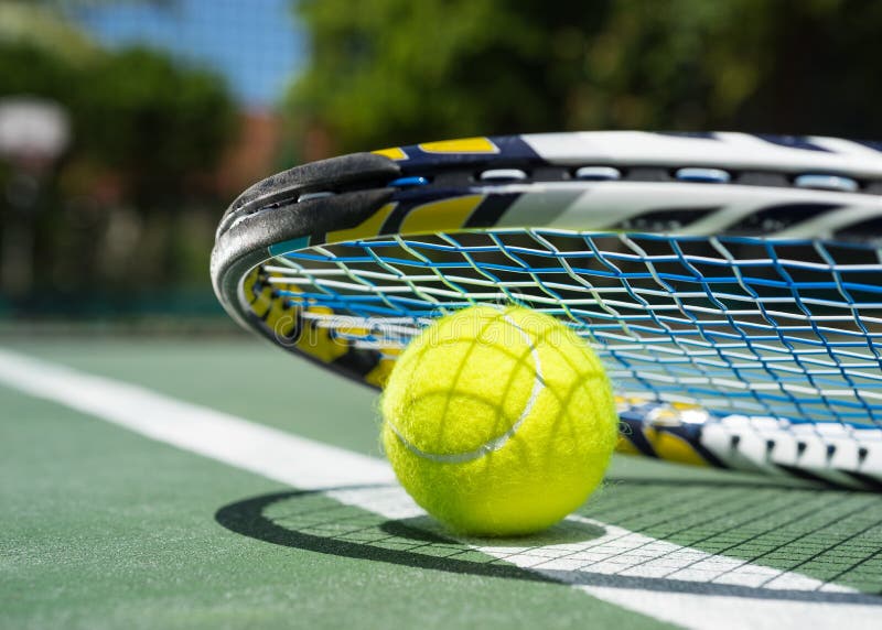 Close Up View Of Tennis Racket And Balls On Clay Tennis Court Stock
