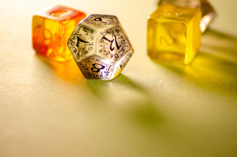 Close-up view of three dice of different shapes for board games and role-playing games royalty free stock photo