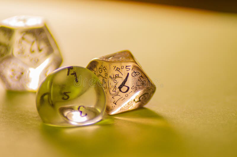 Close-up view of three dice of different shapes for board games and role-playing games stock images