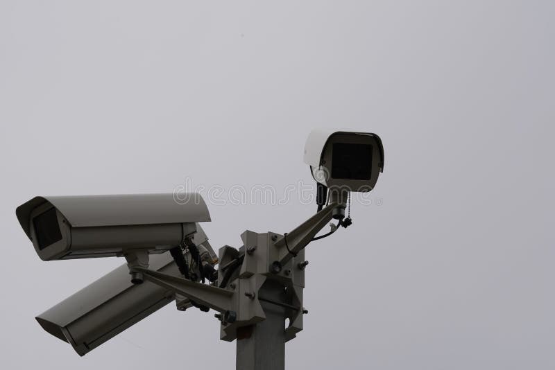 Close Up View on Three Industrial Security CCTV Cameras Installed on Metal Column. Stock Image