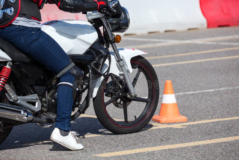 Close up view at training motorbike with person practicing on motor-vehicle proving ground stock image Close up view at training motorbike with person practicing on motor-vehicle proving ground stock image