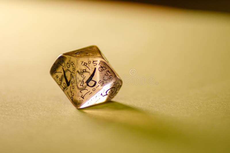 Close-up view of a transparent die for board games and role-playing games royalty free stock image