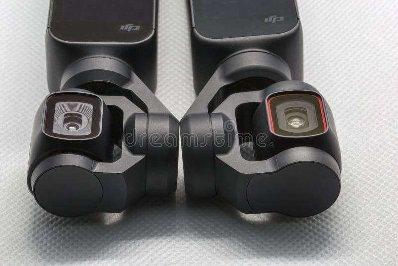 Close up view tree of three-axis gimbal stabilize compact cameras produced by DIJ. On left picture Osmo Pocket lens and on right royalty free stock image