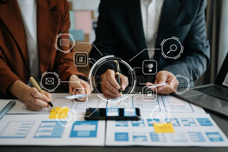 Close up view of UI developer team brainstorming on their project with laptop, smartphone and digital tablet. Creative digital royalty free stock photography