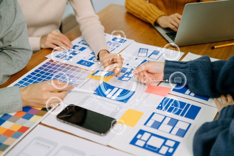 Close up view of UI developer team brainstorming on their project with laptop, smartphone and digital tablet. Creative digital stock photography