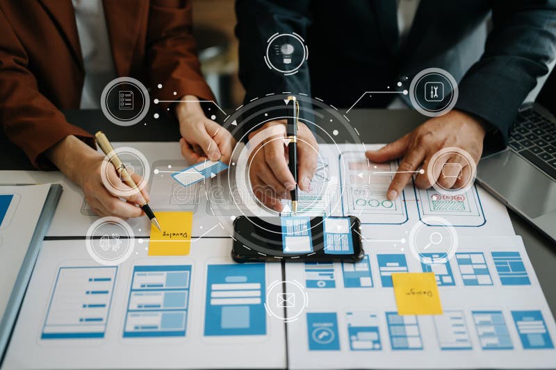 Close up view of UI developer team brainstorming on their project with laptop, smartphone and digital tablet. Creative digital stock photo