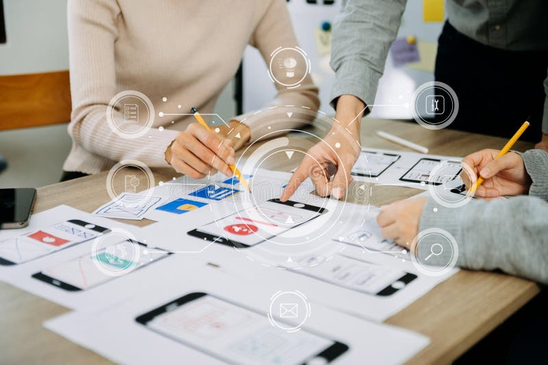 Close up view of UI developer team brainstorming on their project with laptop, smartphone and digital tablet. Creative digital stock photos