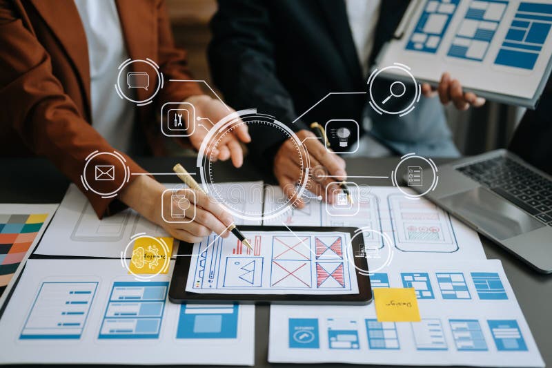Close up view of UI developer team brainstorming on their project with laptop, smartphone and digital tablet. Creative digital stock image
