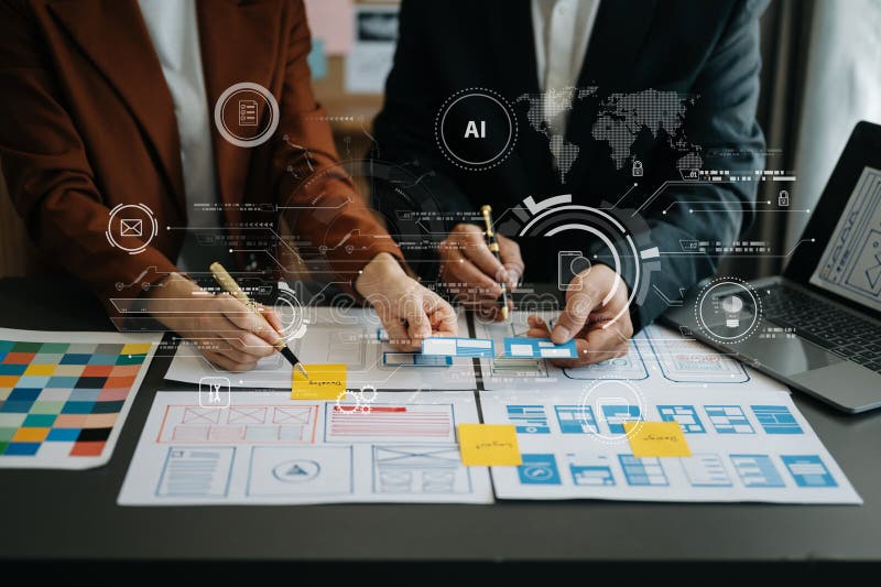 Close up view of UI developer team brainstorming on their project with laptop, smartphone and digital tablet. Creative digital stock photo