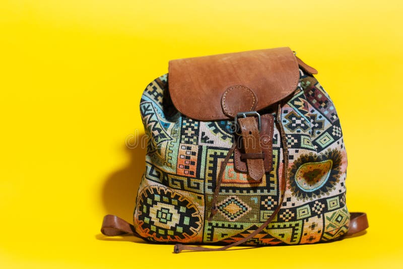 Closeup of Vintage Brown Travel Backpack on Yellow Background. Stock