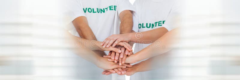 Close up of volunteer team putting hands together and blurry white framing royalty free stock image Close up of volunteer team putting hands together and blurry white framing royalty free stock image